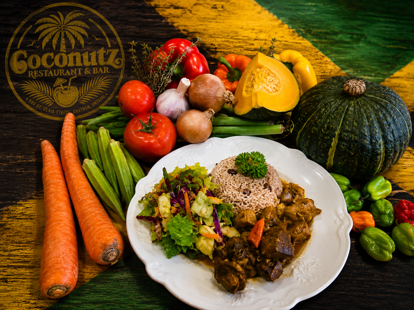 Jamaican curry goat with rice and peas, fresh salad, and island vegetables